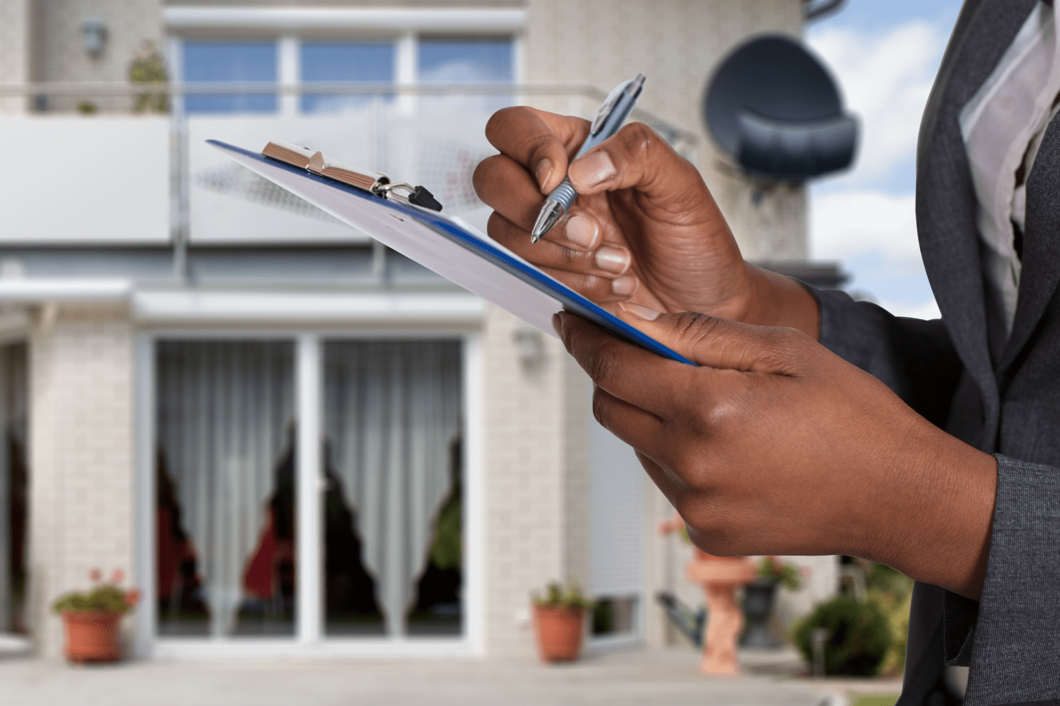 A Person's Hand Completing a Document A Person's Hand Completing a Document